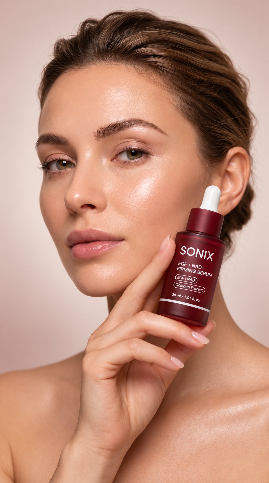 Model holding SONIX serum against her cheek